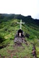 Cross and shrine set high on a hill side.